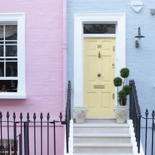 Colorful row houses with a yellow door and steps. related to Discover the Charm of Lancaster Bed and Breakfast