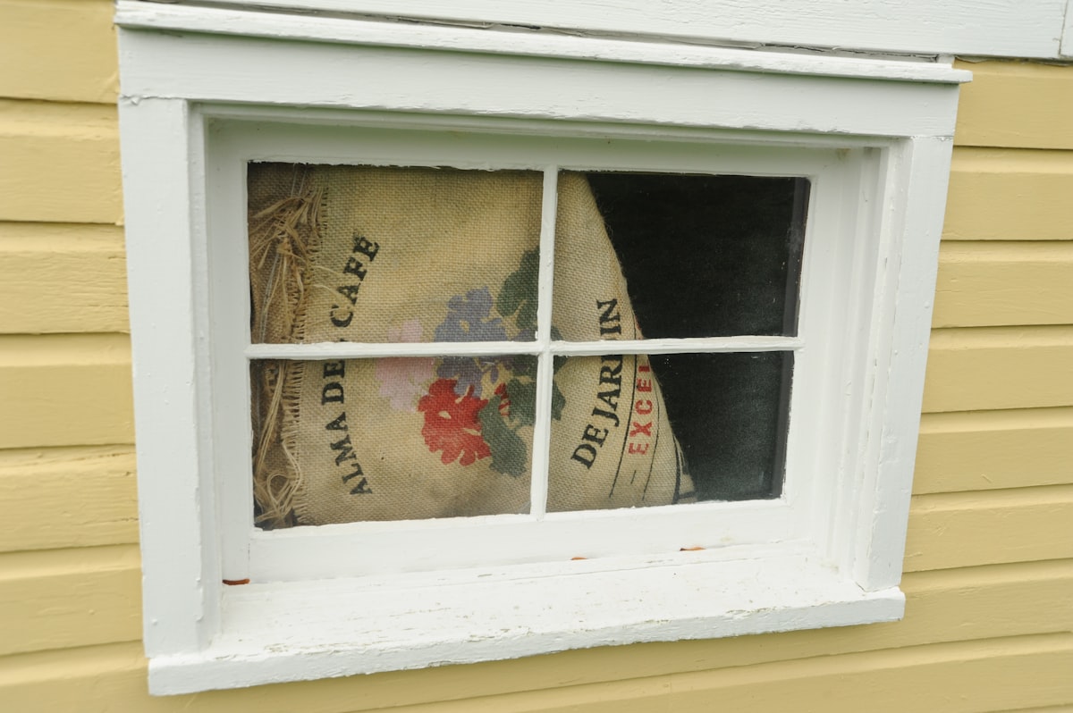 Cover over the basement window, floral print on an Alma De Cafe burlap bag, De Jardin, Excellent, yellow house, white trim, Montana Circle, Fort Lawton, Magnolia, Seattle, Washington, USA related to Burlap Valances DIY: Easy and Elegant Window Treatment