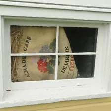 Cover over the basement window, floral print on an Alma De Cafe burlap bag, De Jardin, Excellent, yellow house, white trim, Montana Circle, Fort Lawton, Magnolia, Seattle, Washington, USA related to Burlap Valances DIY: Easy and Elegant Window Treatment
