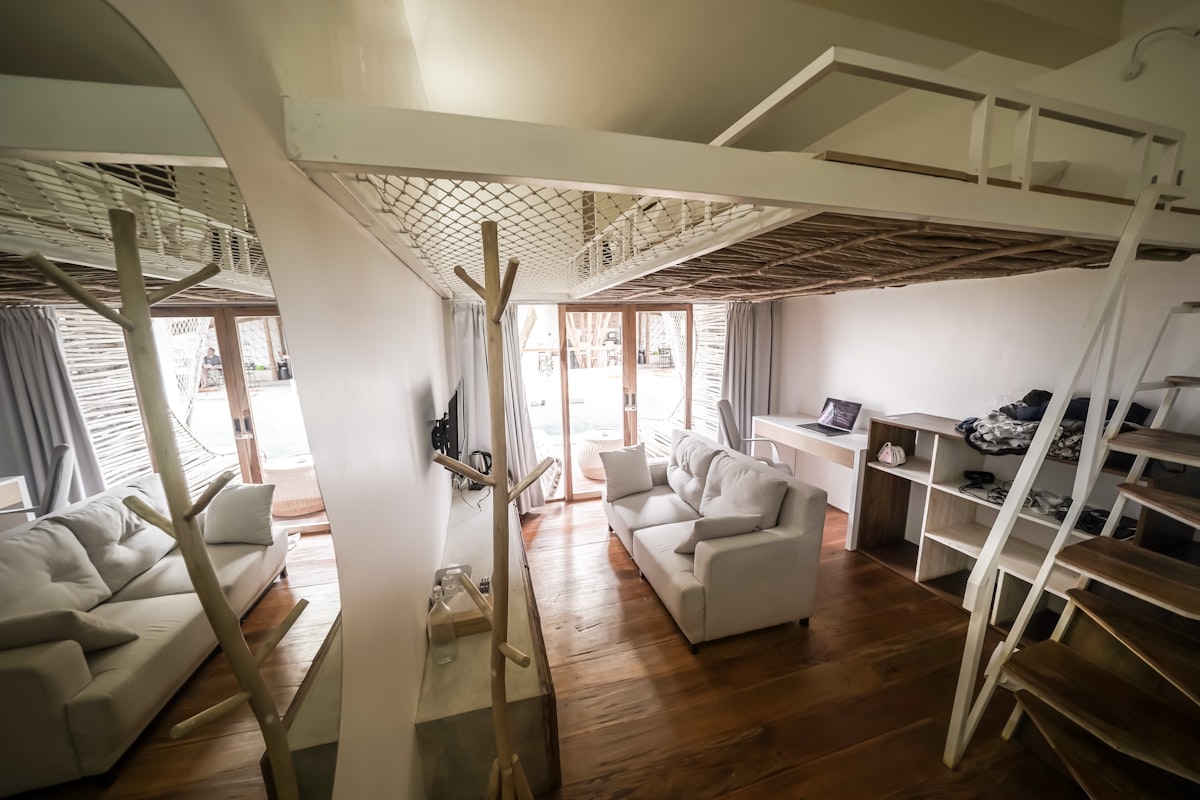 Cozy living room with white sofas and loft bed. related to Elevate Your Productivity: The Ultimate Guide to Loft Beds with Desk