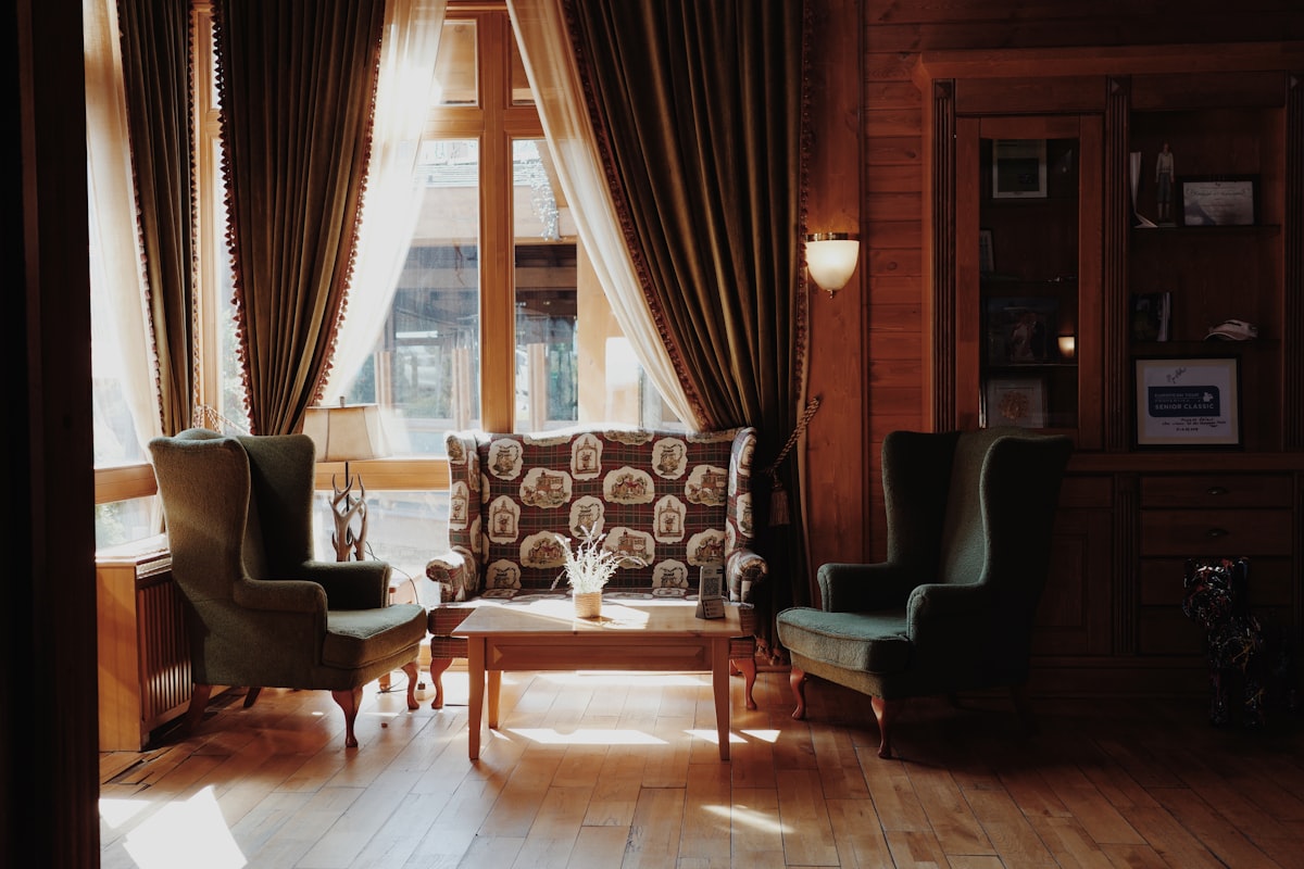 Cozy seating area with vintage chairs and patterned sofa. related to Elegant Living Room Drapes and Valances for a Stylish Space