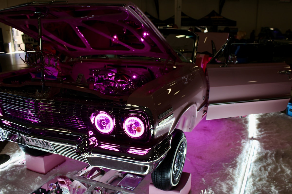 Customized car with pink neon lights and chrome details related to Top Car Beds for Girls: Combining Style and Comfort