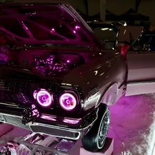 Customized car with pink neon lights and chrome details related to Top Car Beds for Girls: Combining Style and Comfort