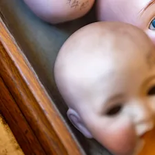 Doll heads from the 1800s still awaiting bodies in a glass chewing gum case in the historic Dry Goods store museum in Virginia City, Montana, USA in August, 2025. related to Discover the Perfect Baby Doll Bunk Beds