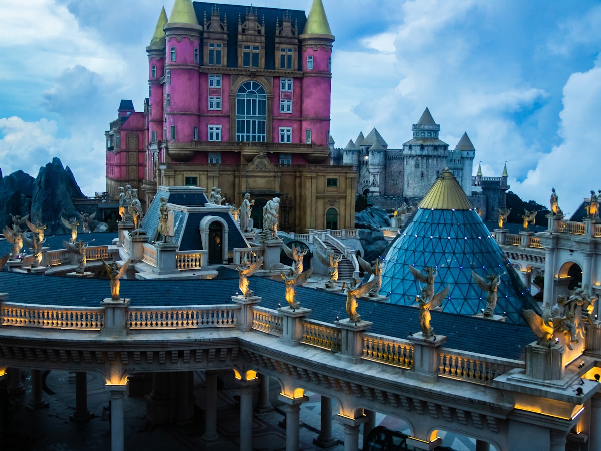 Elaborate fantasy castle complex with ornate architecture and statues. related to Transform Your Child's Room with Enchanting Princess Castle Beds