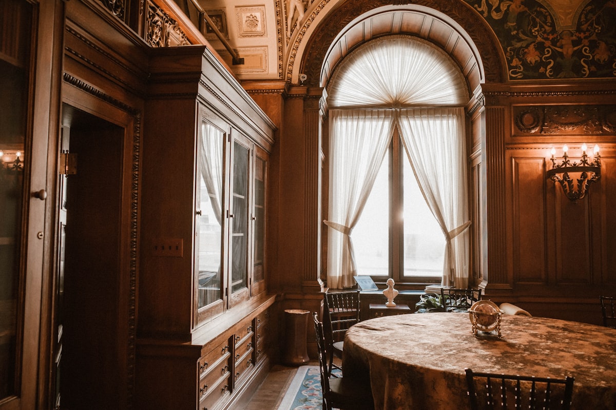 Elegant room with large arched window and ornate furniture related to Elegant Dining Room Valance Ideas to Elevate Your Space