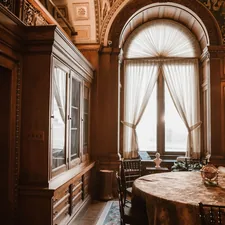 Elegant room with large arched window and ornate furniture related to Elegant Dining Room Valance Ideas to Elevate Your Space