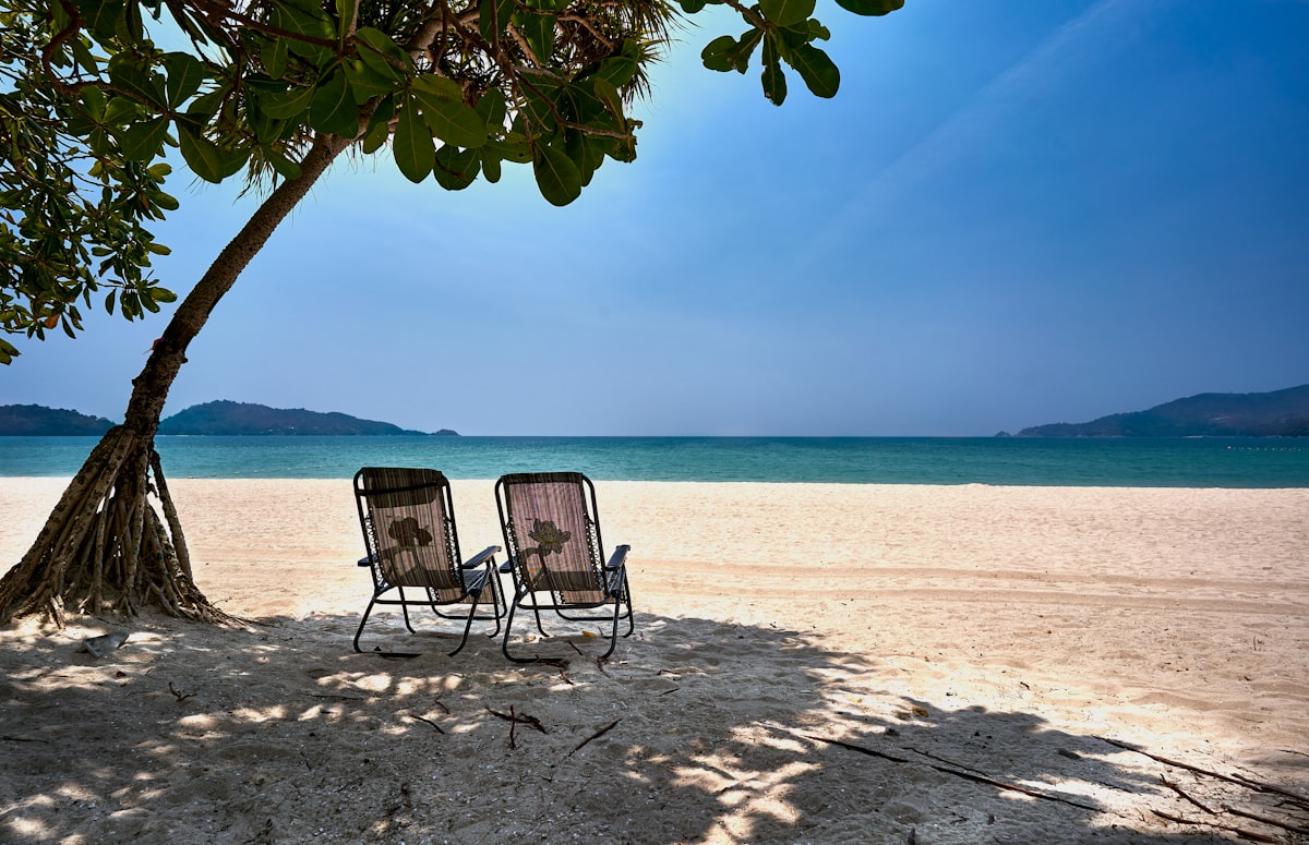 Empty beach and unused sun chairs at a beach in Phuket related to Discover the Comfort of Holiday Inn Bedding