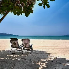 Empty beach and unused sun chairs at a beach in Phuket related to Discover the Comfort of Holiday Inn Bedding