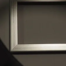 Empty ornate picture frame casting a shadow related to Transform Your Bedroom with a Sleek Silver Bed Frame