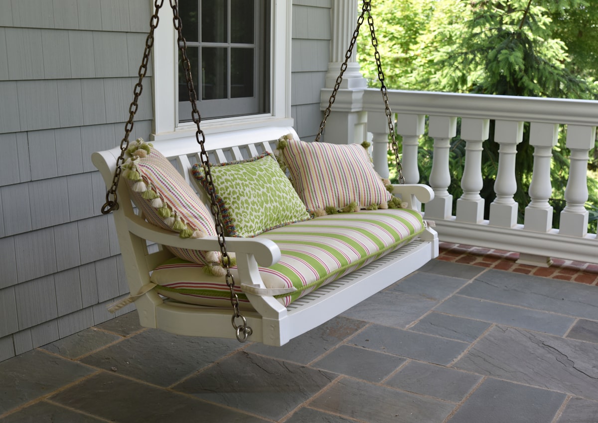 empty swing chair on porch related to The Ultimate Guide to Porch Swing Beds: Relaxation at Its Finest