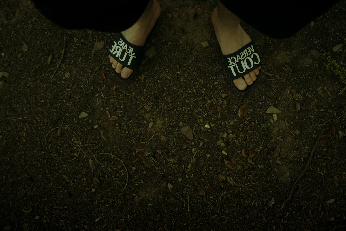 Feet wearing slides on a dirt path. related to The Comfort and Style of Juicy Couture Bedding