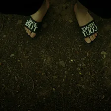 Feet wearing slides on a dirt path. related to The Comfort and Style of Juicy Couture Bedding