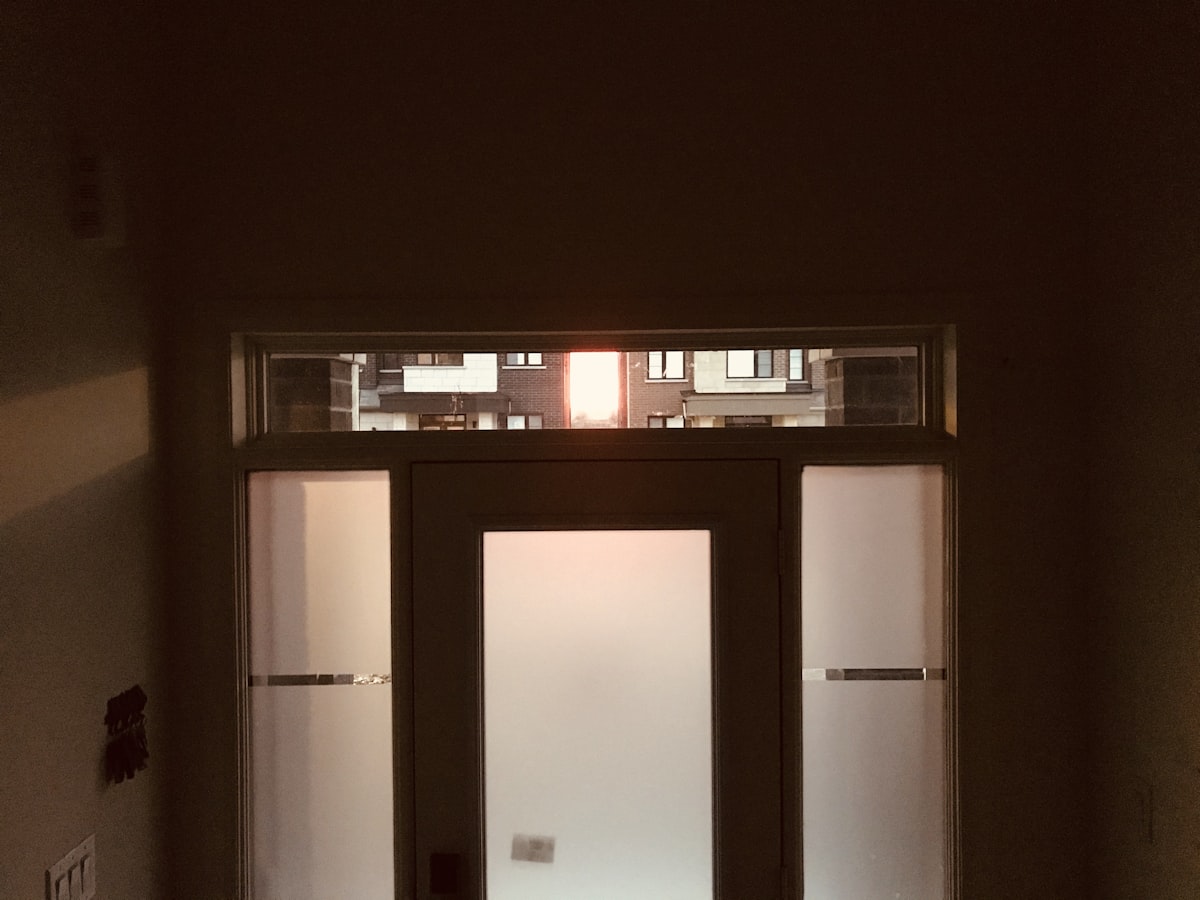 Front door at sunrise. Interior angles and shadows. related to Enhancing Your Home's First Impression with Entryway Doors with Sidelights