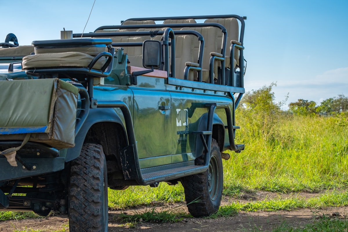 Game drive vehicle in front of grass related to Vision Quest Safari Bed & Breakfast