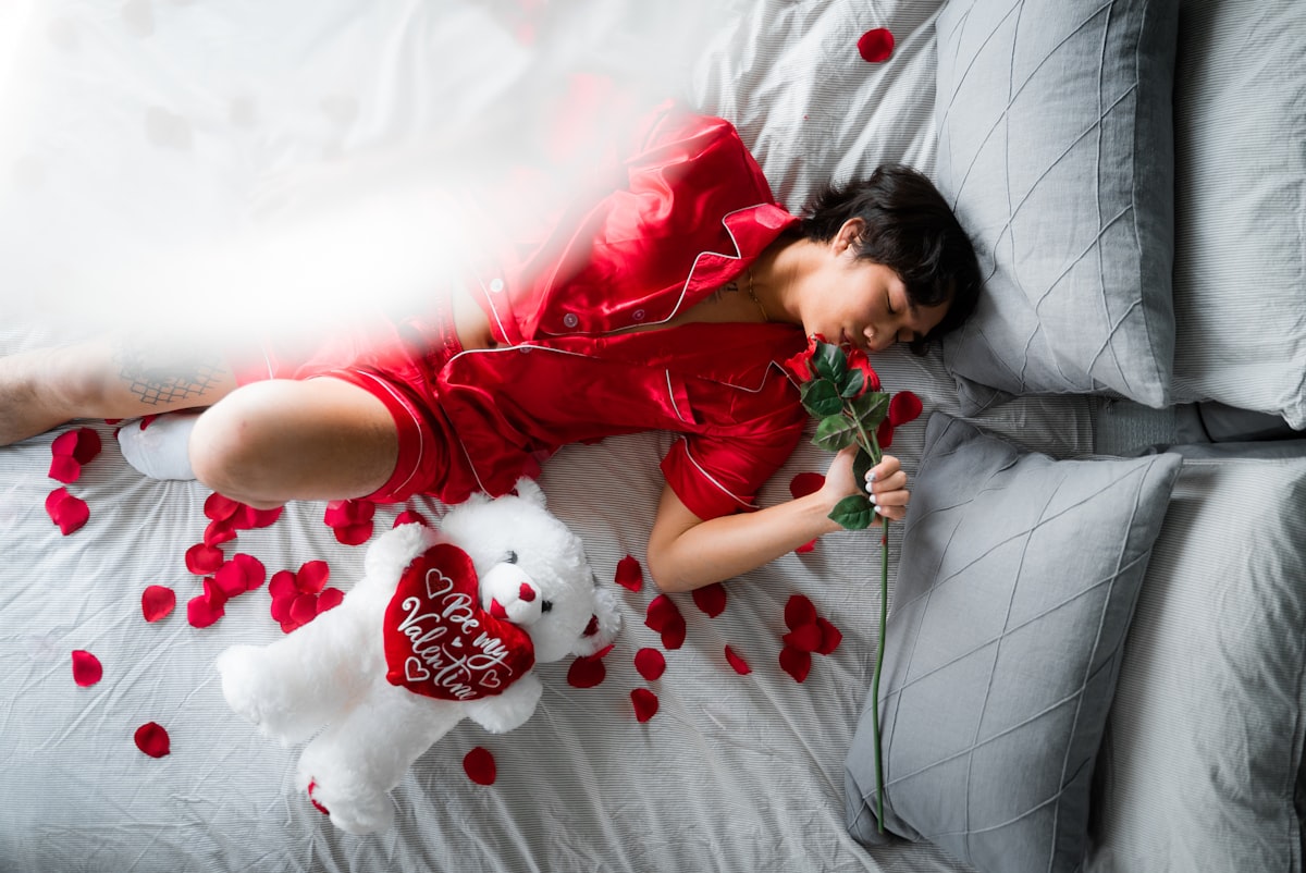 girl in red t-shirt lying on bed related to Elevate Your Love Life: The Allure of Romantic Bedding Sets