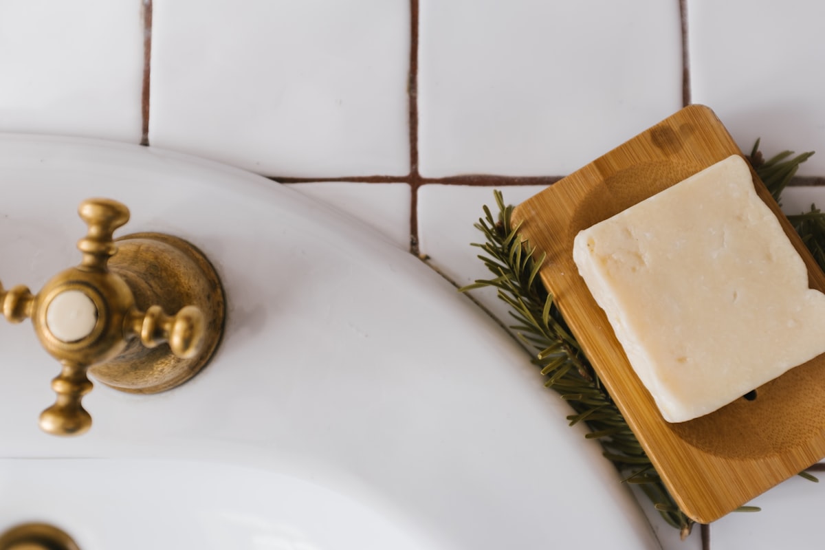 gold round ornament on white ceramic sink related to The Surprising Comfort of a Bar of Soap in Bed