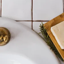 gold round ornament on white ceramic sink related to The Surprising Comfort of a Bar of Soap in Bed