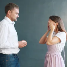 Good-looking man is proposing to pretty girl giving engagement ring in jewellery box, young lady is excited. Couple is standing against gray background. related to Bed Bug Detectives: Unmasking the Hidden Invaders