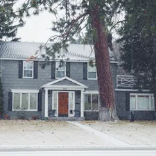 gray and white wooden house near green leaf tree related to Charming Stays in Bend, Oregon