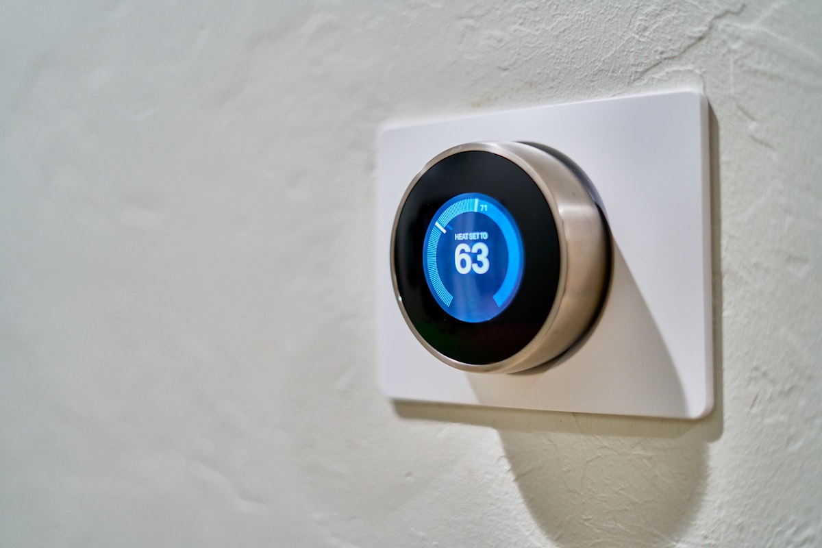 gray Nest thermostat displaying at 63 related to Revolutionize Your Home with an Efficient Entryway Storage System
