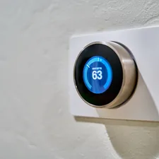 gray Nest thermostat displaying at 63 related to Revolutionize Your Home with an Efficient Entryway Storage System