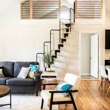 gray sofa beside white wall related to Elevate Your Space: The Ultimate Guide to Living Room Window Valances