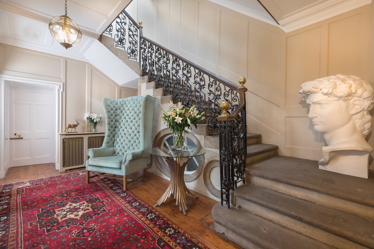 gray wing chair near strais related to Elegant Entryways: Incorporating an Antique Entryway Bench