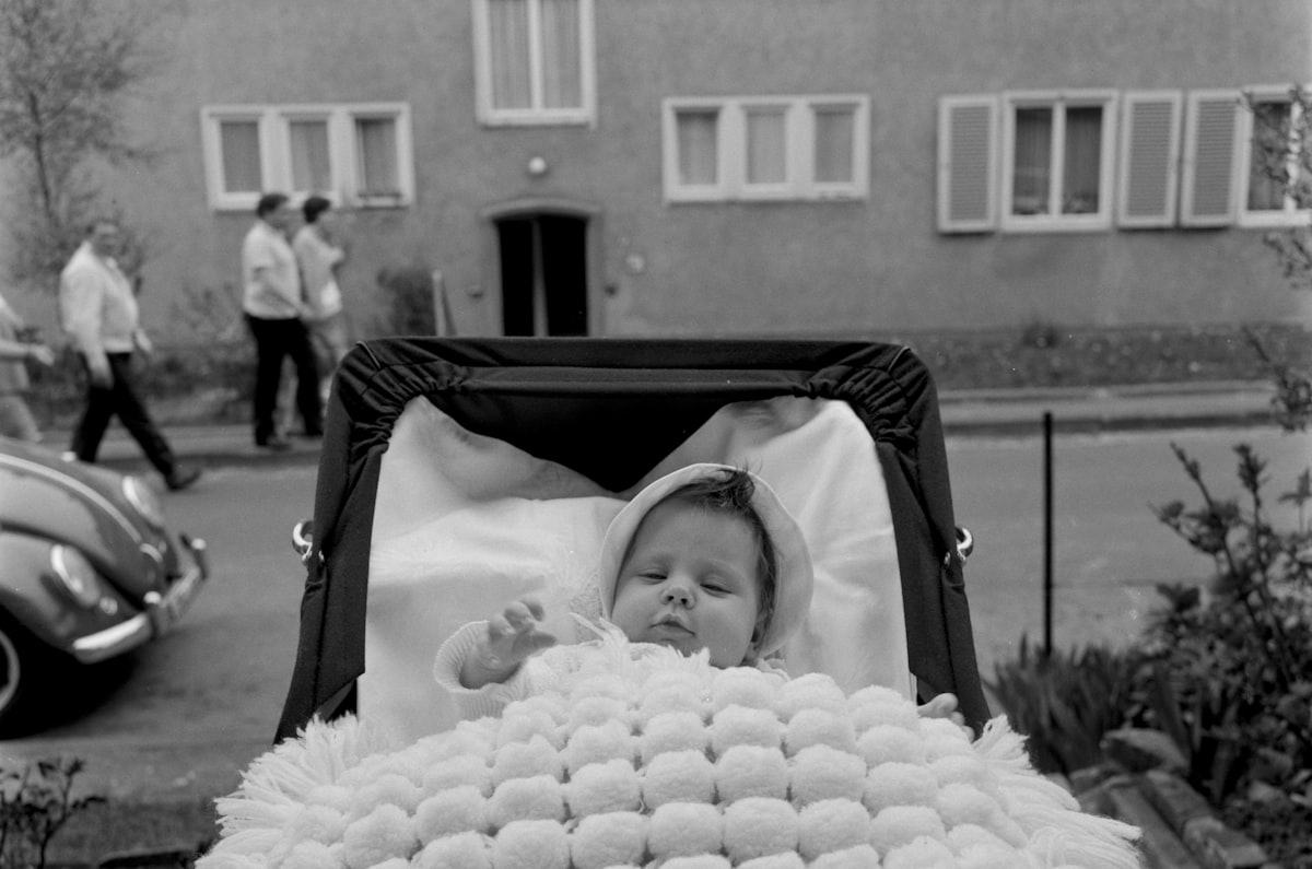 grayscale photo of baby in stroller related to Baby on the Move: The Ultimate Guide to Eddie Bauer Infant Travel Bed