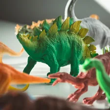 green and orange dragon plastic toy related to Roaring into Sweet Dreams: Circo Dinosaur Bedding for Budding Paleontologists