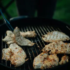 grilled meat on black charcoal grill related to Chiminea with Grill: Your All-in-One Outdoor Cooking Solution