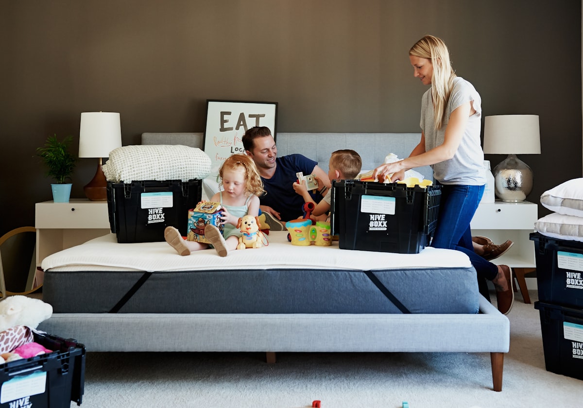 group of people sitting on white couch related to The Ultimate Guide to Bed in a Box