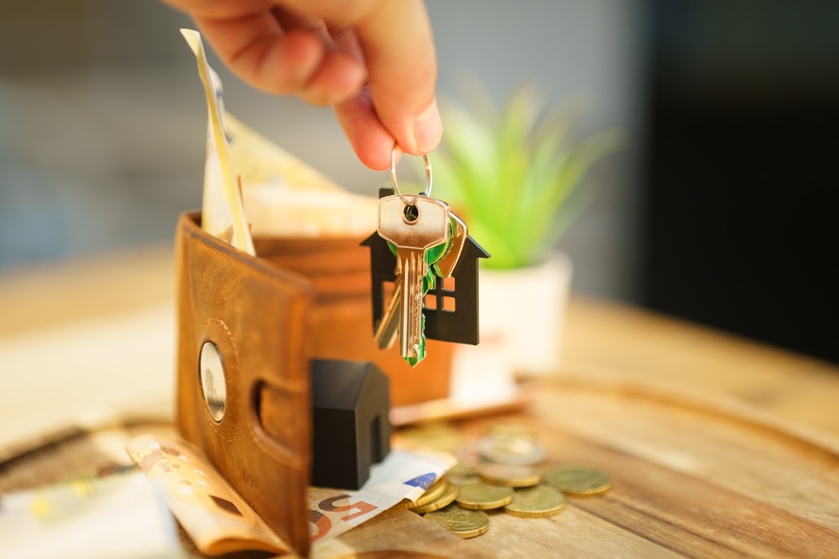 Hand hold door keys new home household expense bills wallet related to Streamline Your Entryway with an Entryway Key Organizer