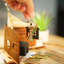 Hand hold door keys new home household expense bills wallet related to Streamline Your Entryway with an Entryway Key Organizer