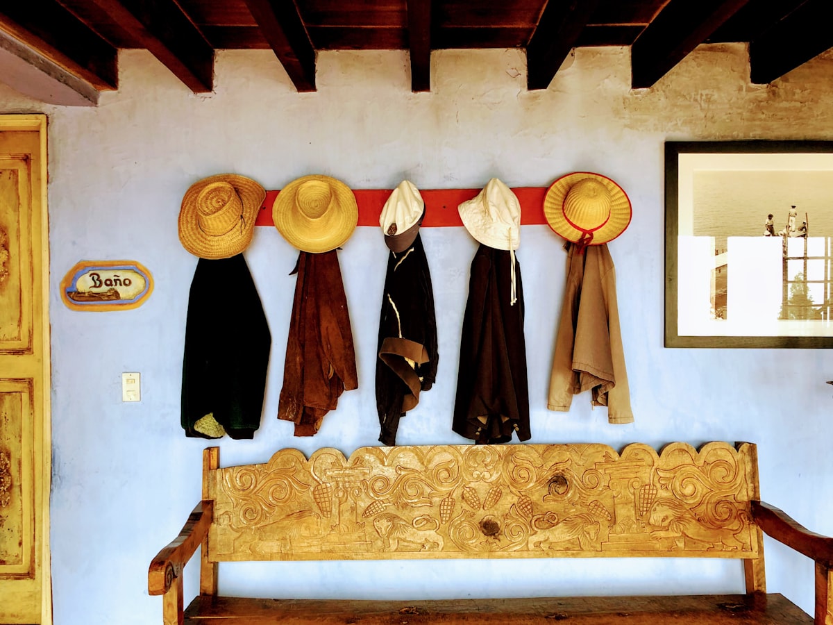 hats and coats hanging on the wall related to Elevate Your Home's First Impression with Entryway Bench Pottery Barn