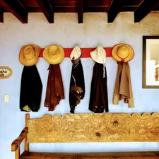 hats and coats hanging on the wall related to Elevate Your Home's First Impression with Entryway Bench Pottery Barn