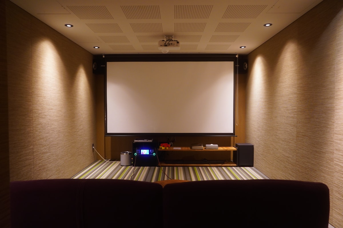 Home theater with a screen and comfortable seating. related to Ultimate Movie Night: Choosing the Perfect Movie Room Couch Bed