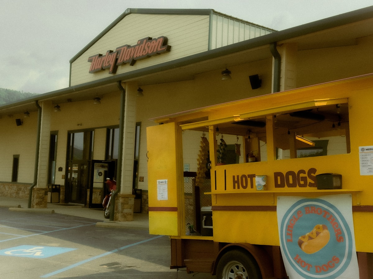 Hot dog cart outside a building with a sign. related to Ultimate Comfort: The Hot Dog Dog Bed Experience