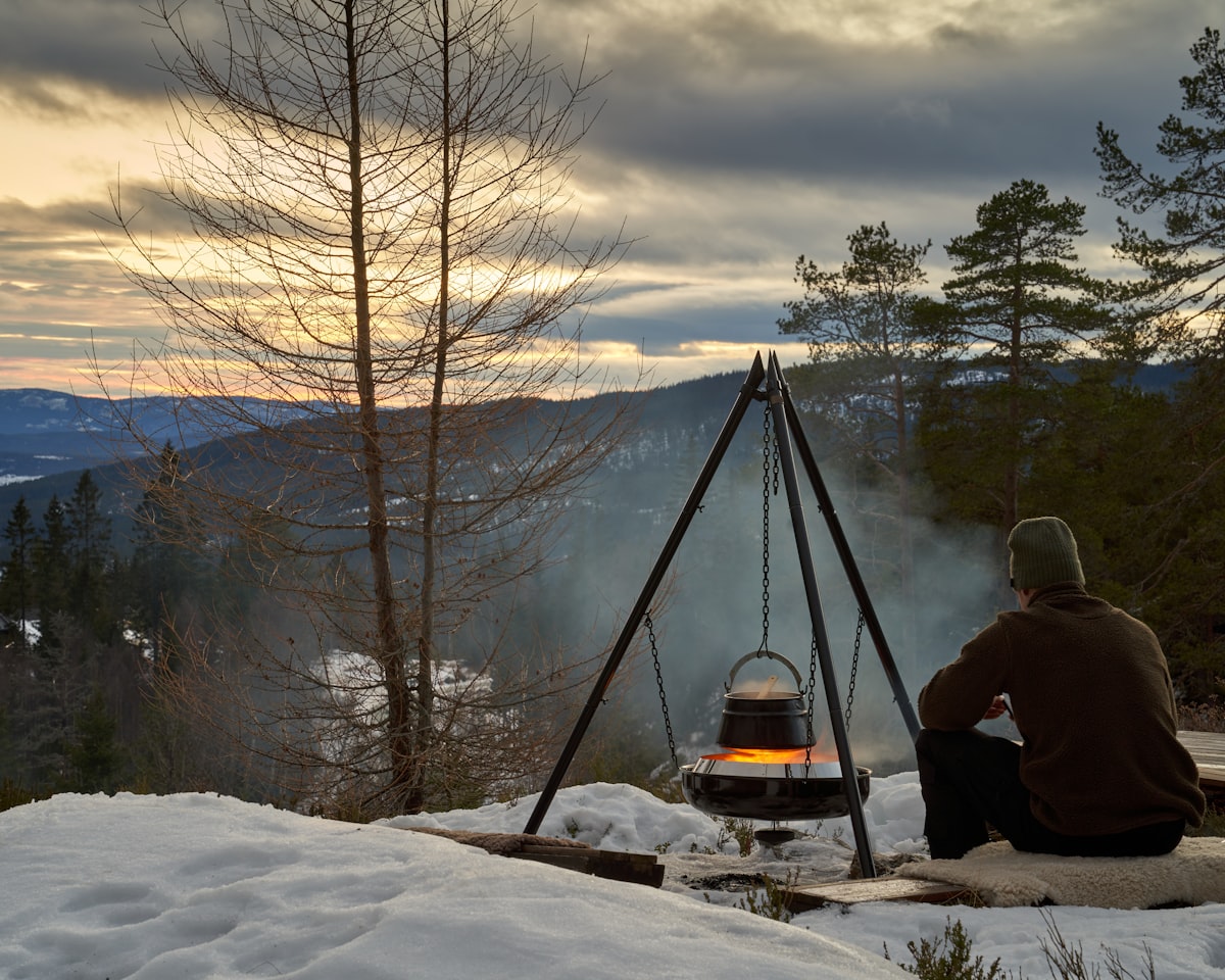 Hungarian goulash is cooking on open fire in the Norwegian woods during winter. View to lake Krøderen during evening light with colorful sunset. related to Discover the Warmth of Chimineas at Home Depot: A Comprehensive Guide to Clay Models