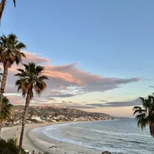 laguna beach at sunset with palm trees related to Paradise Found: Your Ultimate Guide to Laguna Beach Bed and Breakfast