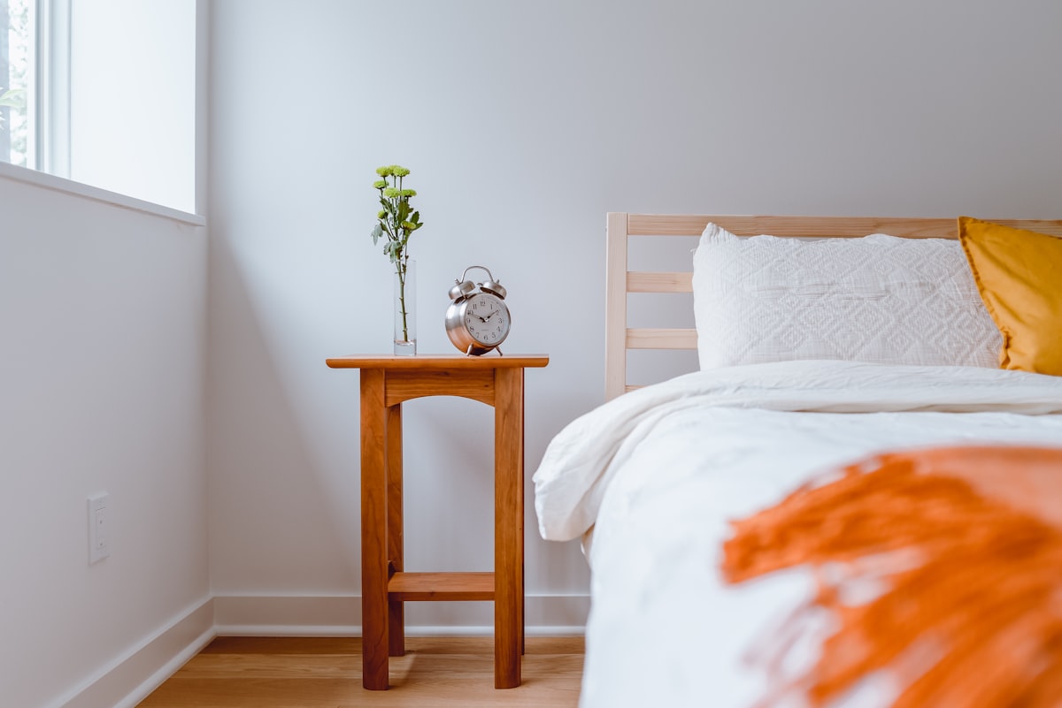 Light and Airy Bedroom with Old clock on Nightstand and colorful pillow related to Brighten Up Your Bedroom with a Yellow Coverlet for Your King-Sized Bed