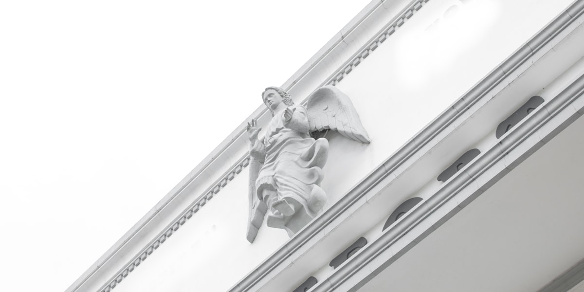 low-angle photography of angel on wall related to A Comprehensive Guide to Window Valance Clips