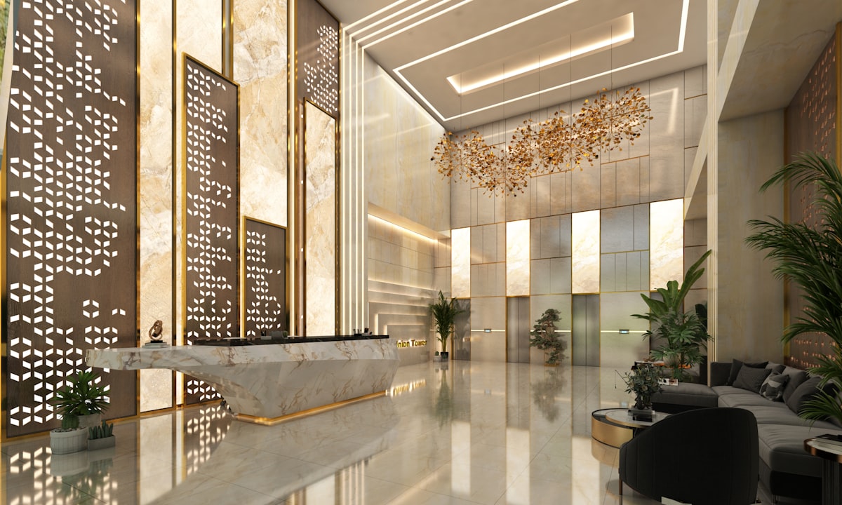 Luxurious Lobby Design with Marble Reception Desk, Gold Accents, Modern Lighting, Decorative Partition Walls, and Elegant Furnishings for a High-End Corporate Atmosphere related to Welcome Home: Inspiring Entryway Furniture Ideas