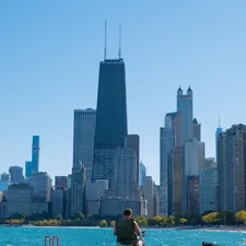 man and woman sitting on boat on water near city buildings during daytime related to How to Handle Bed Bugs in Michigan