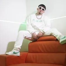 man in white hoodie sitting on red couch related to Level Up Your Lounge: Swag Curtains with Valance