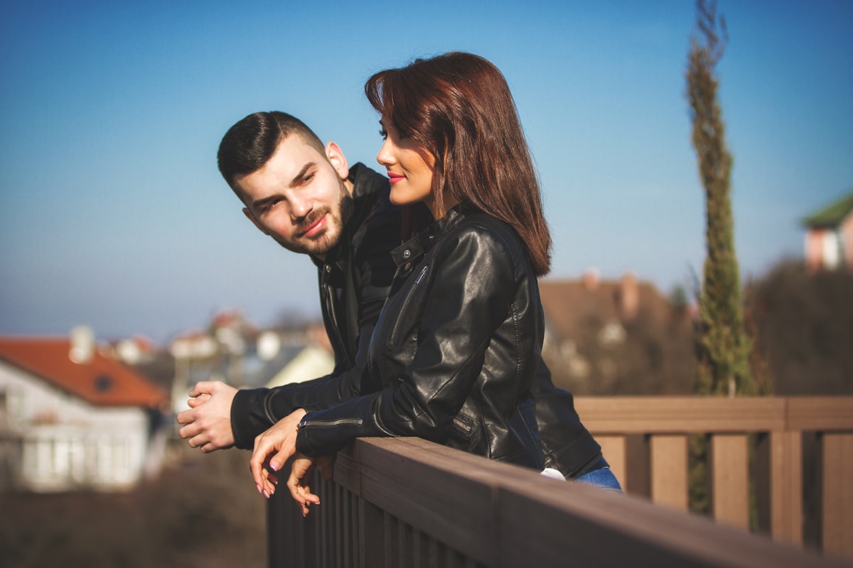 Man looking at women, both smiling. related to Stay Up to Date with Trend-Savvy Insights
