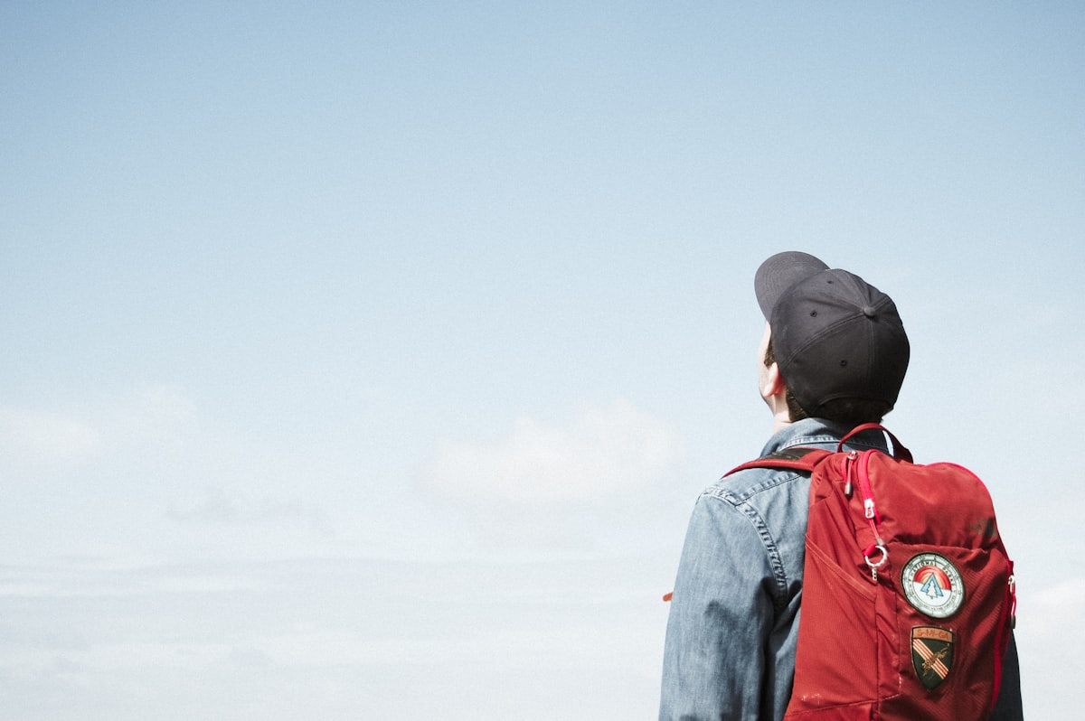 man looking out related to Comfortable Solutions for Young Travelers