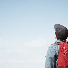 man looking out related to Comfortable Solutions for Young Travelers