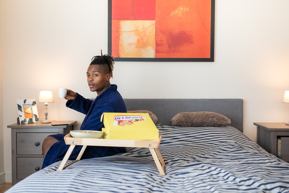man sits on bed related to The Ultimate Guide to Choosing Bed Rails for Adults