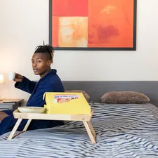 man sits on bed related to The Ultimate Guide to Choosing Bed Rails for Adults